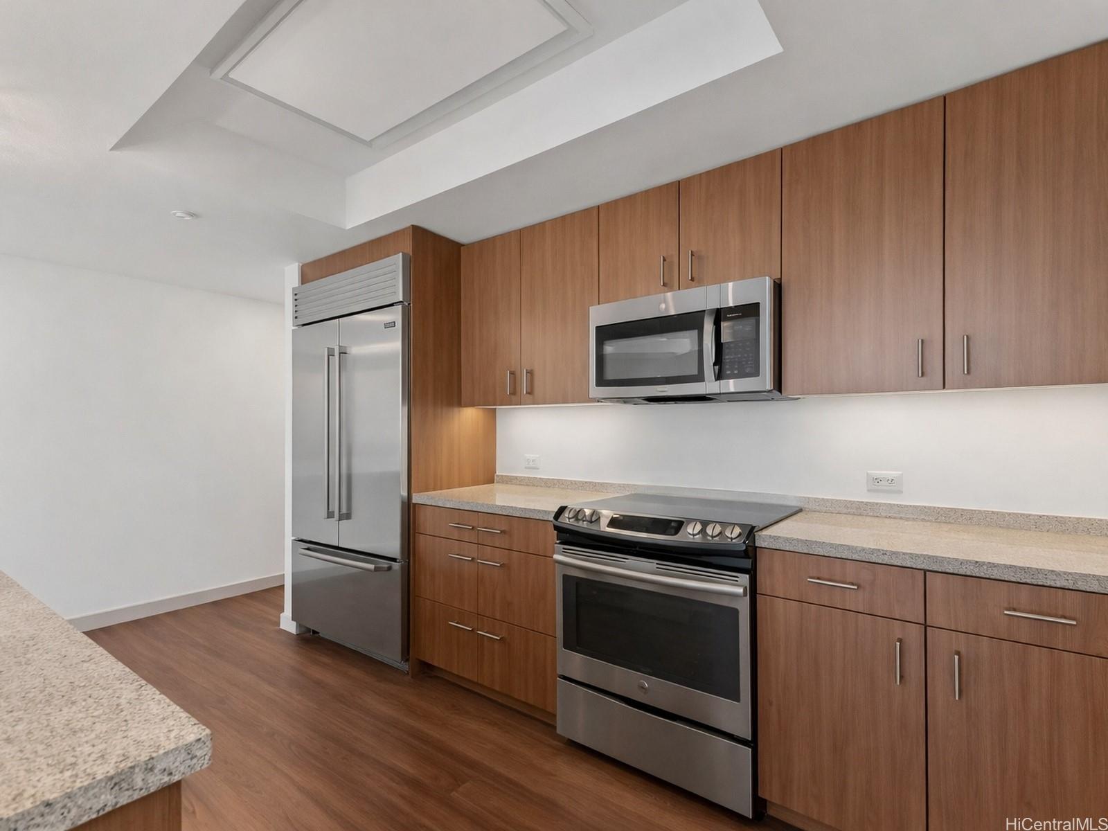 555 South Street, Unit 1805 Honolulu, HI 96813 - Photo 3 of 20 a kitchen with granite countertop wooden cabinets and stainless steel appliances