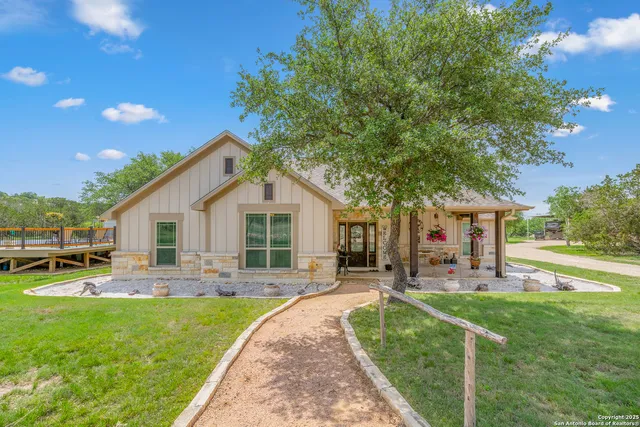 a front view of house with yard and outdoor seating