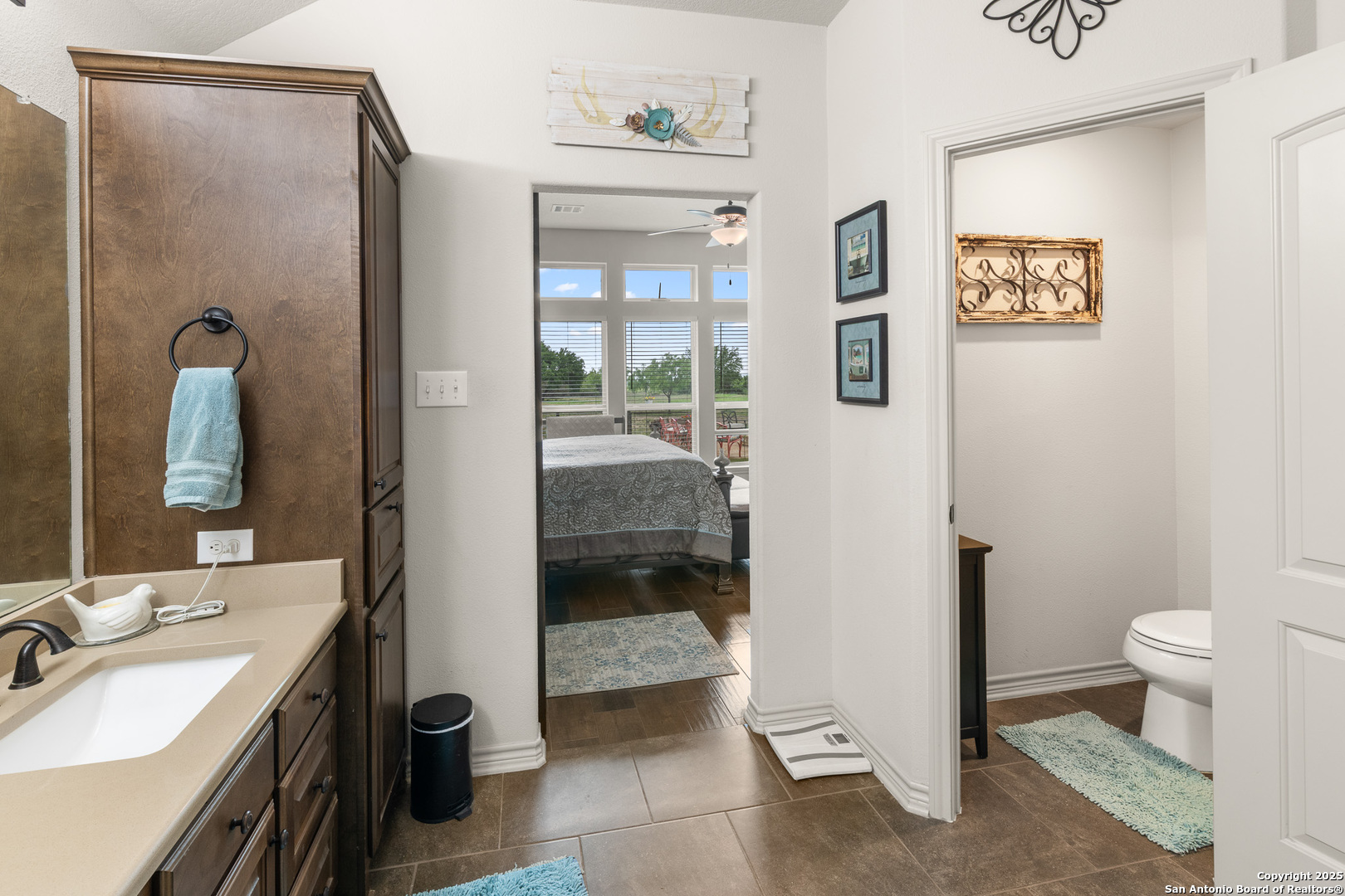 1446 Big Draw Drive Junction, TX 76849 - Photo 12 of 55 a bathroom with a granite countertop sink a mirror and a toilet