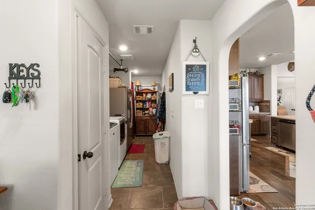 a view of a hallway with living room and utility room