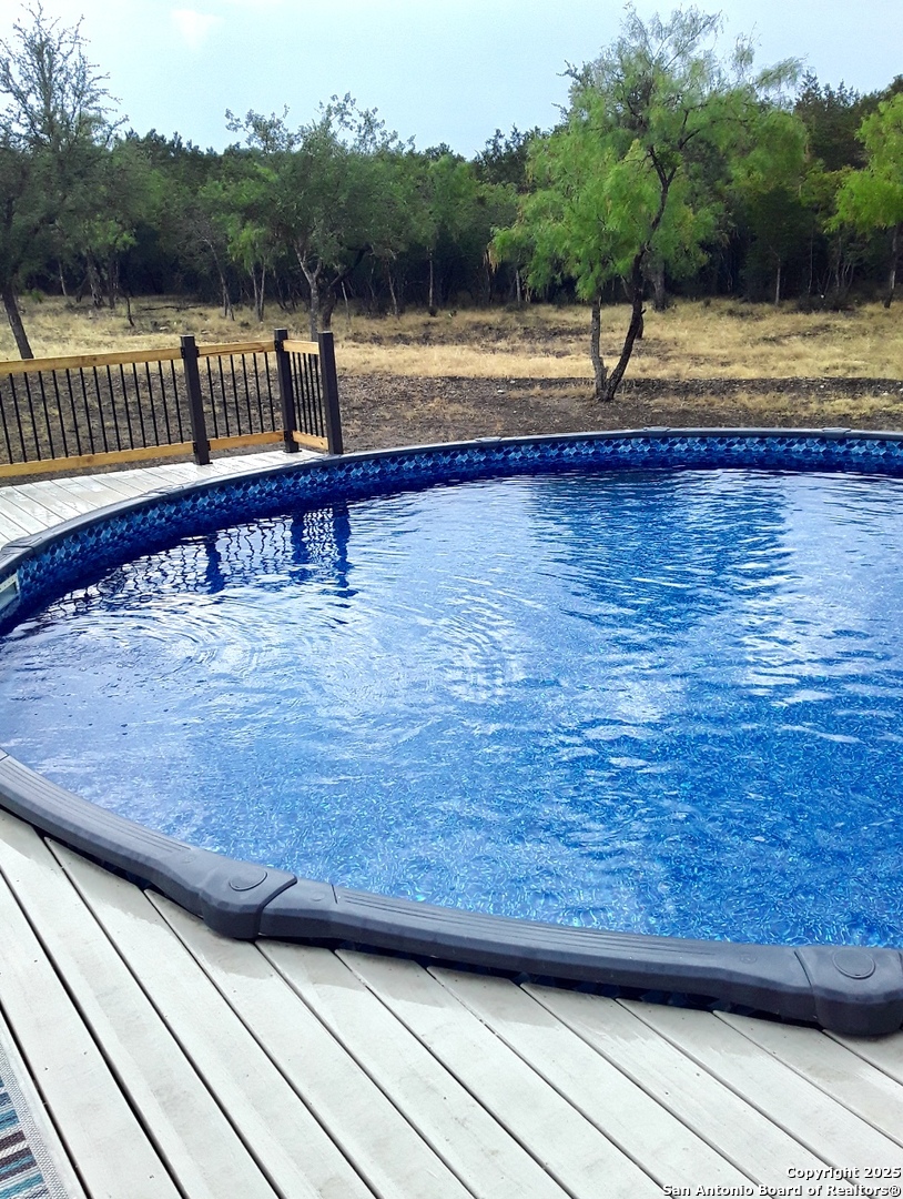 1446 Big Draw Drive Junction, TX 76849 - Photo 23 of 55 a view of a swimming pool with a lake view