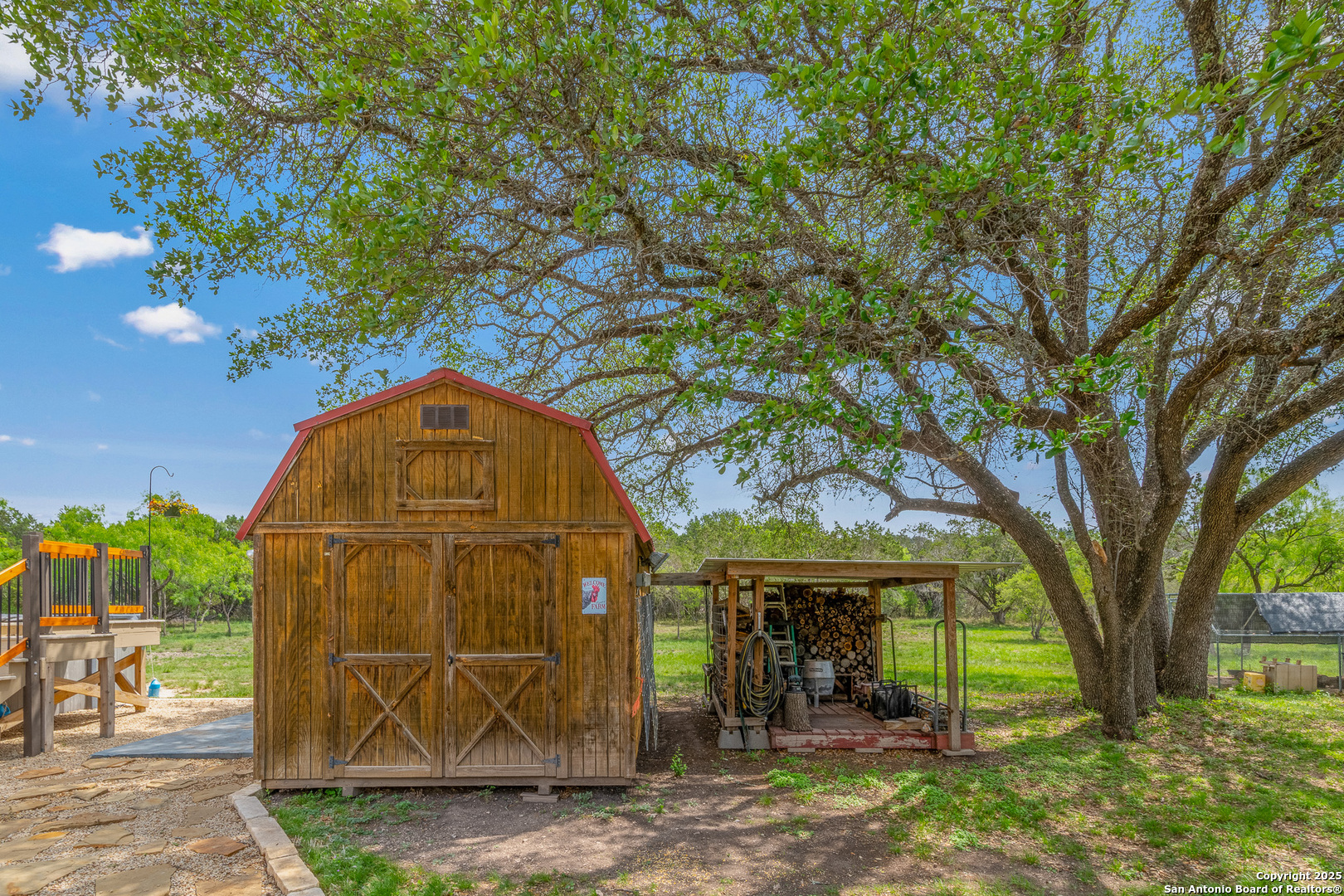 1446 Big Draw Drive Junction, TX 76849 - Photo 29 of 55 a view of a house with large trees and a small yard