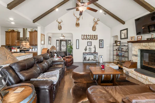 a living room with furniture fireplace and flat screen tv