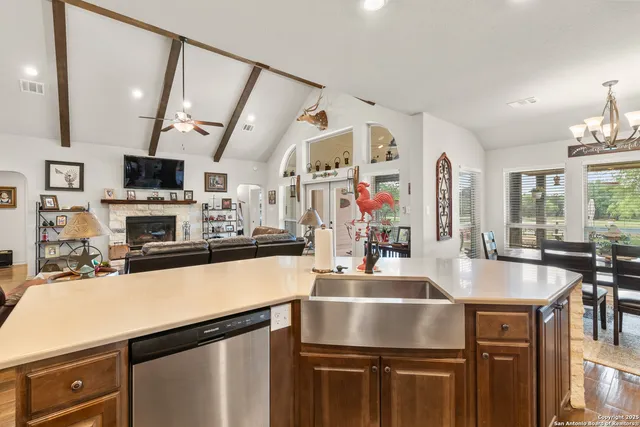 a kitchen with stainless steel appliances granite countertop a sink a stove and a refrigerator