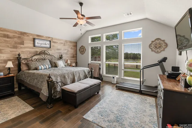 a living room with furniture a flat screen tv and a window