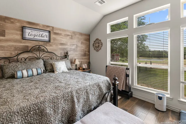 a bedroom with a bed and a window