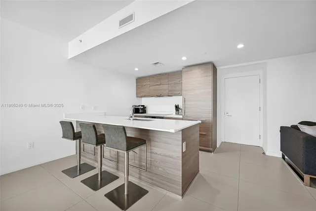 a stove top oven sitting inside of a kitchen