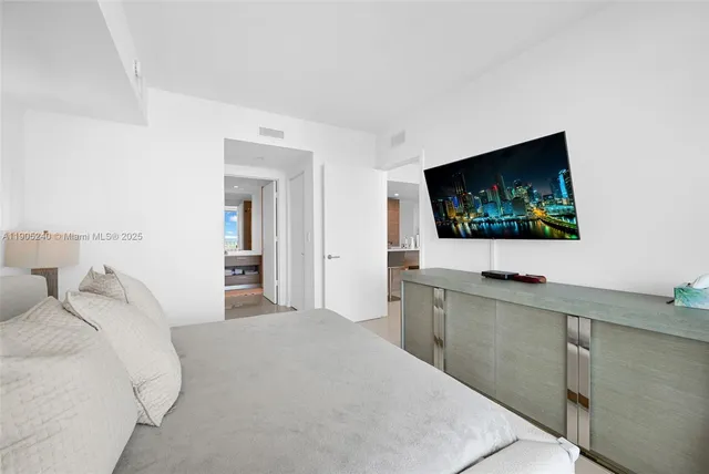 a bathroom with a bathtub shower sink and mirror