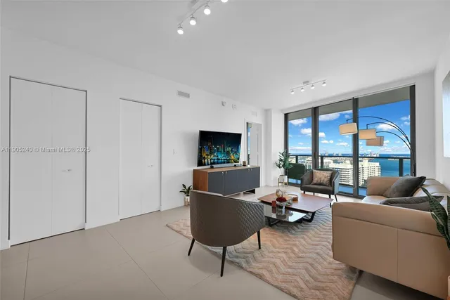 a living room with furniture fireplace and flat screen tv