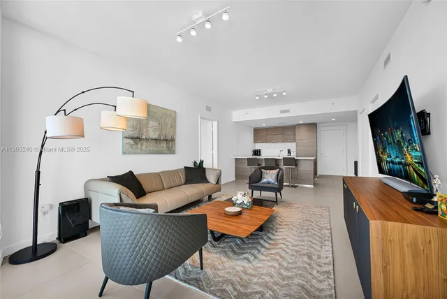 a view of living room with furniture and a open kitchen view