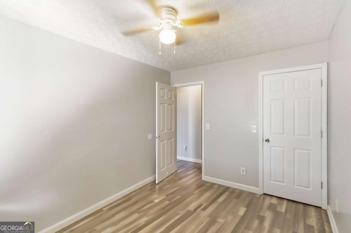 5559 Strathmoor Manor Circle Lithonia, GA 30058 - Photo 13 of 22 wooden floor in an empty room
