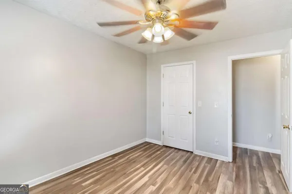 a view of an empty room with wooden floor