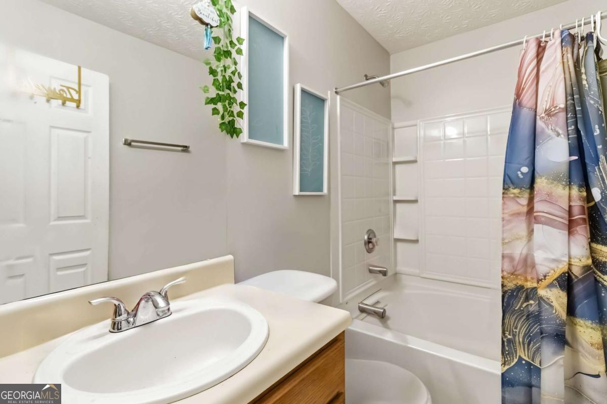 5559 Strathmoor Manor Circle Lithonia, GA 30058 - Photo 18 of 22 a bathroom with a sink and a mirror