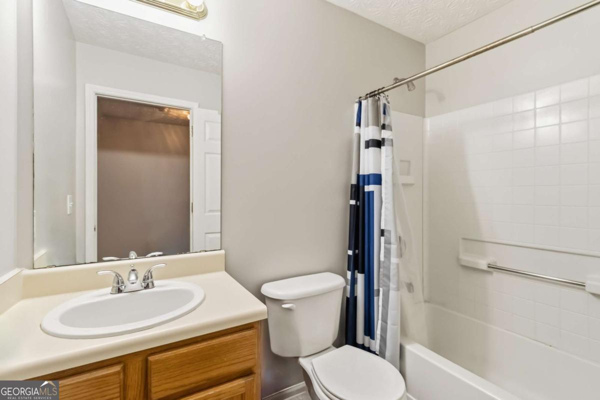5559 Strathmoor Manor Circle Lithonia, GA 30058 - Photo 19 of 22 a bathroom with a sink toilet and shower