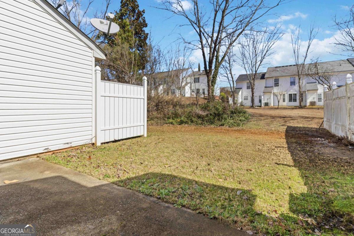 5559 Strathmoor Manor Circle Lithonia, GA 30058 - Photo 22 of 22 a view of a yard covered with snow in front of house