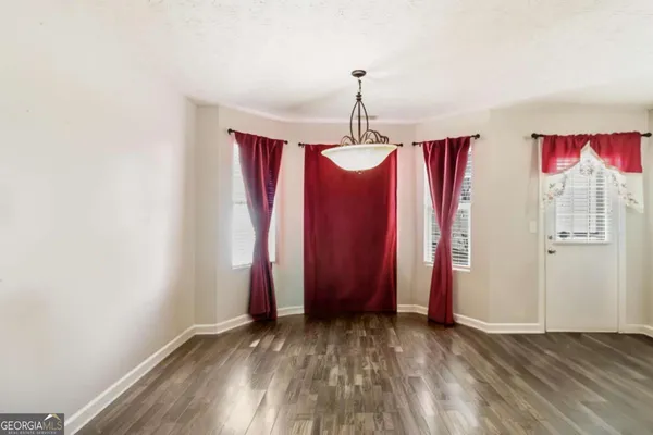 a view of a room with window & closet area