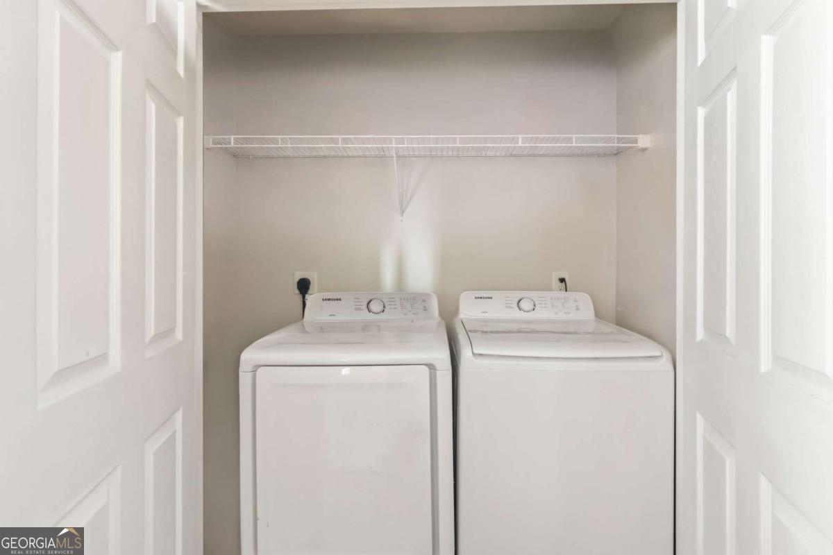 5559 Strathmoor Manor Circle Lithonia, GA 30058 - Photo 10 of 22 a utility room with dryer and washer