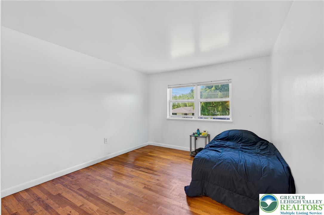 1411 Lieb Road Easton, PA 18040 - Photo 23 of 46 Hardwood flooring extends through this naturally illuminated primary bedroom.