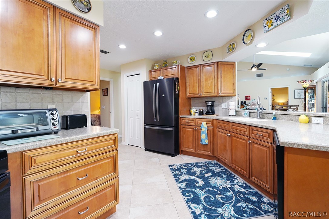 800 Balmoral Court Inverness, FL 34453 - Photo 16 of 72 a kitchen with stainless steel appliances granite countertop a refrigerator and a stove top oven