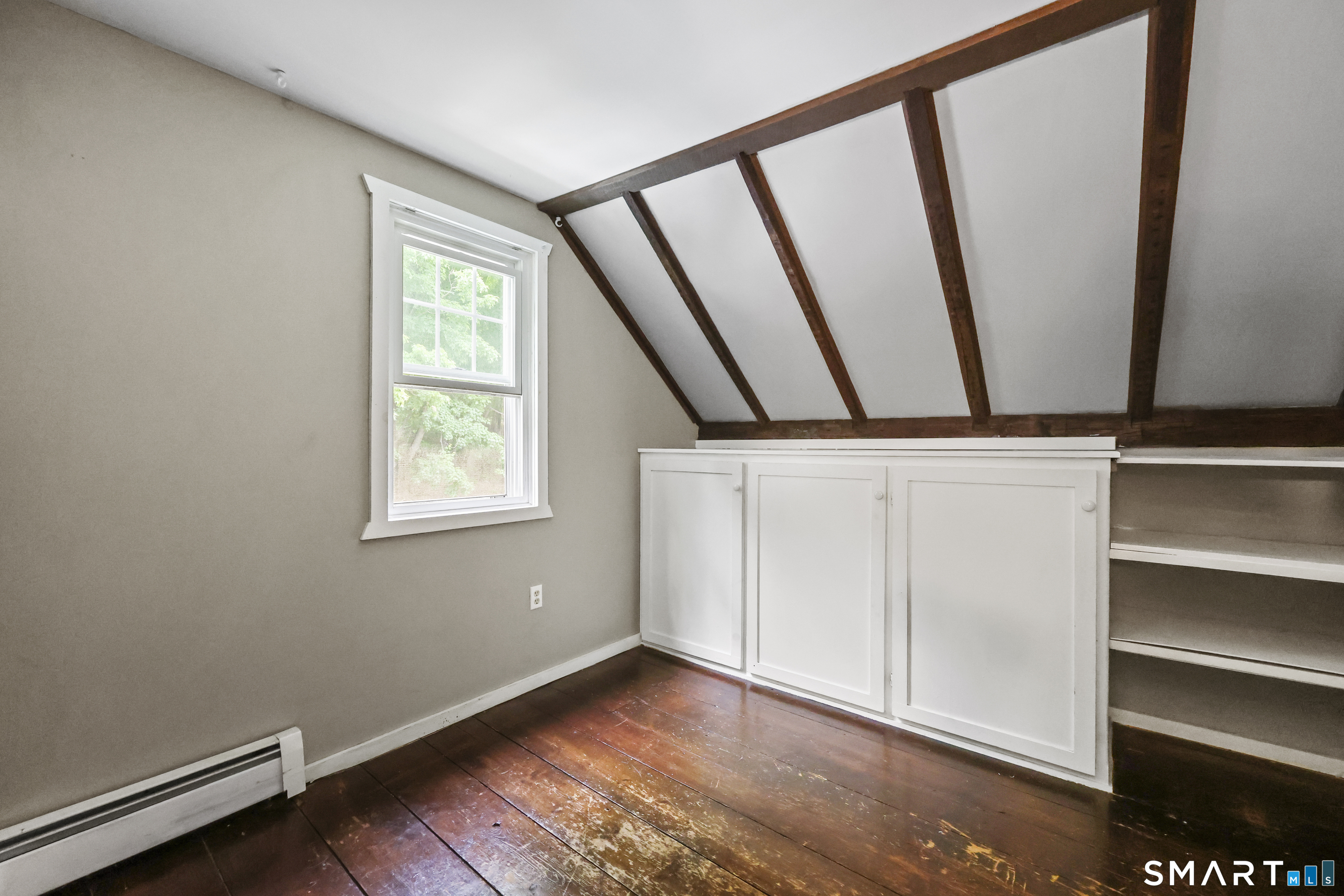 917 Hopewell Road Glastonbury, CT 06033 - Photo 24 of 39 a view of an empty room with wooden floor and a window