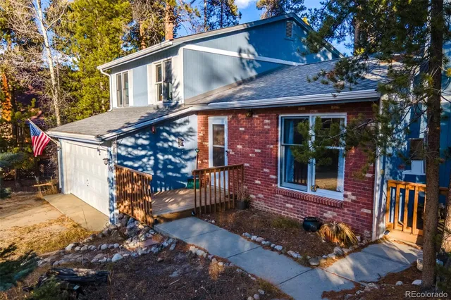a view of a deck with a large tree and wooden fence