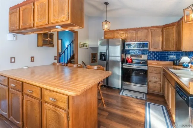 a kitchen with stainless steel appliances granite countertop a sink and cabinets