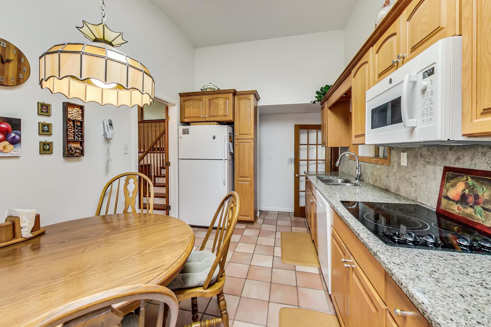 322 Voltz Road Northbrook, IL 60062 - Photo 7 of 21 a kitchen with stainless steel appliances granite countertop a stove a sink and a refrigerator