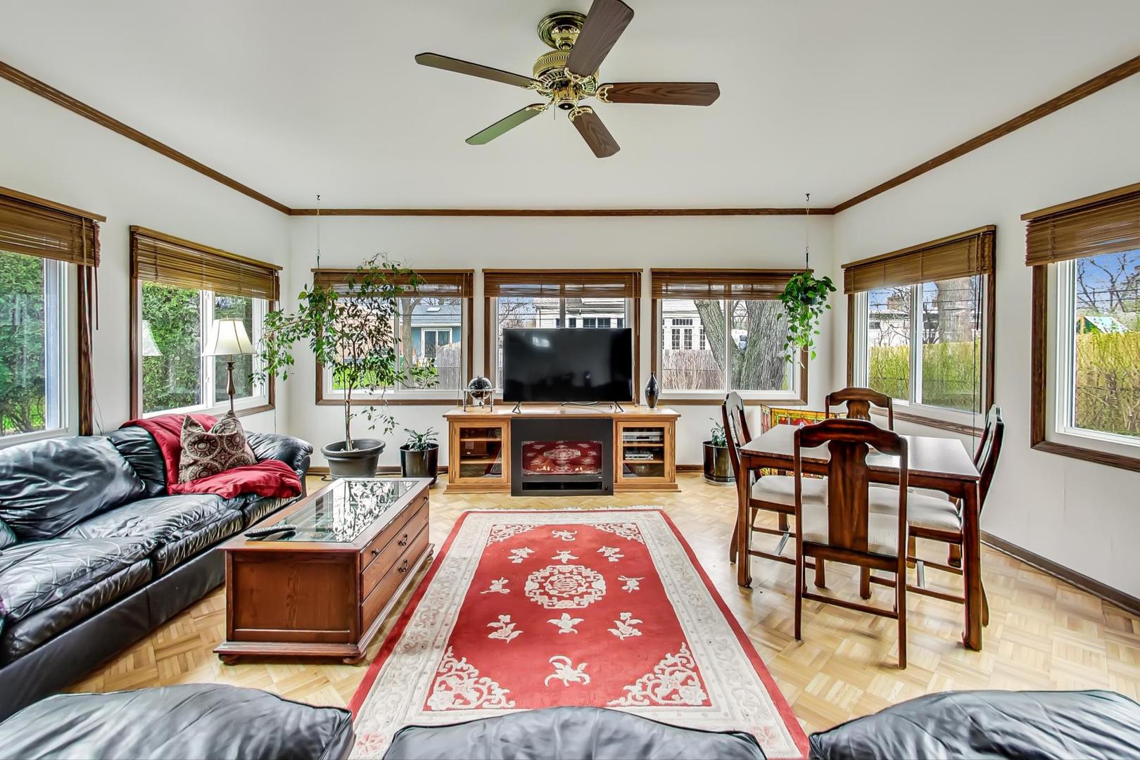 322 Voltz Road Northbrook, IL 60062 - Photo 8 of 21 a living room with furniture flat screen tv and a large window