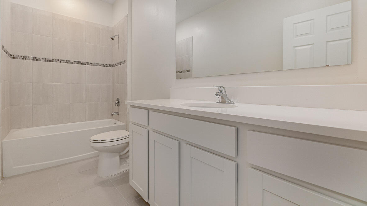 83 52nd Square Vero Beach, FL 32968 - Photo 15 of 21 a bathroom with a sink a toilet and shower