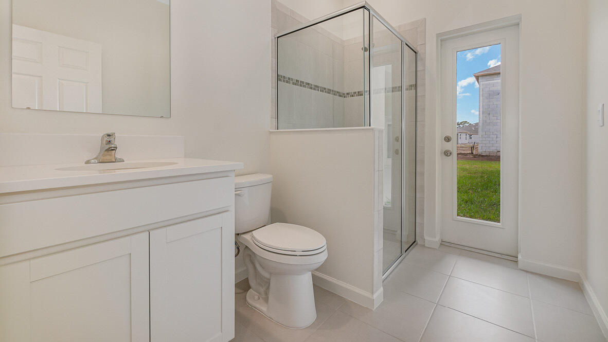 83 52nd Square Vero Beach, FL 32968 - Photo 16 of 21 a bathroom with a sink a toilet and shower