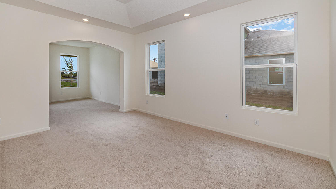 83 52nd Square Vero Beach, FL 32968 - Photo 18 of 21 an empty room with windows and entrance to other room