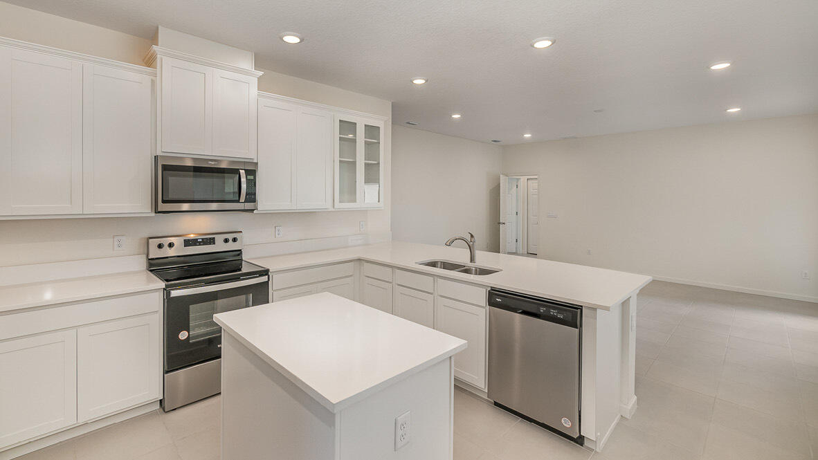 83 52nd Square Vero Beach, FL 32968 - Photo 5 of 21 a kitchen that has a sink and a stove in it