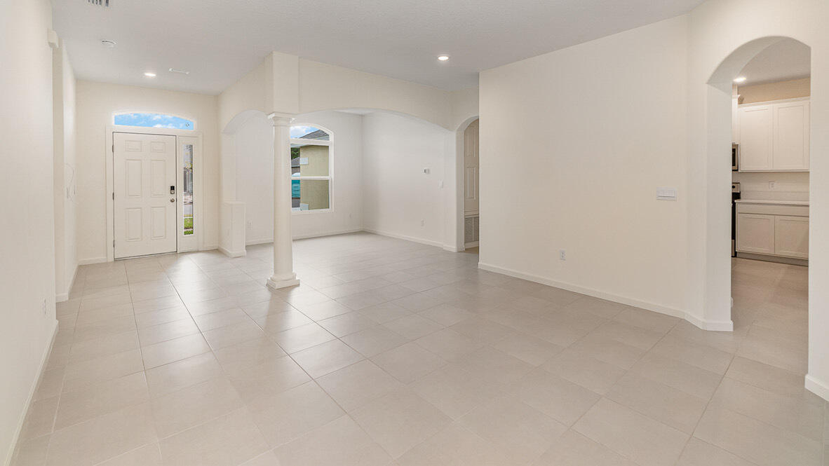 83 52nd Square Vero Beach, FL 32968 - Photo 8 of 21 wooden floor in an empty room with a window