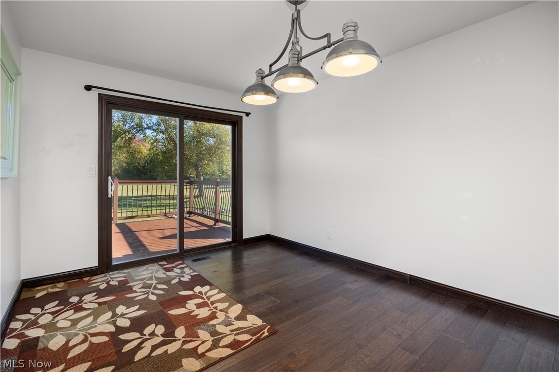 6760 Mason Road Berlin Heights, OH 44814 - Photo 9 of 49 Spare room featuring dark wood-style floors and baseboards