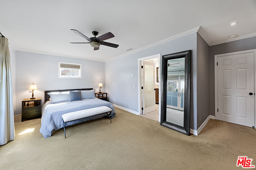 697 Washington Boulevard Marina del Rey, CA 90292 - Photo 19 of 23 a spacious bedroom with a bed and a chandelier