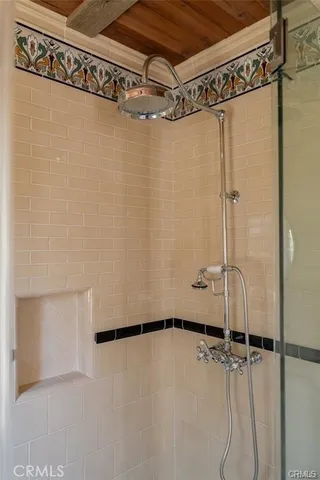 a bedroom with a bed windows and wooden floor