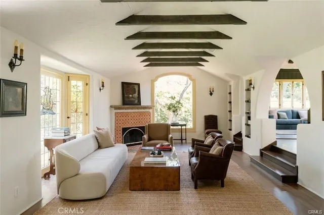 a living room with furniture fireplace and flat screen tv