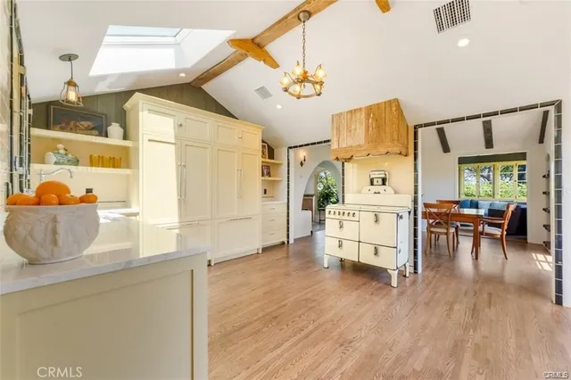 a living room with furniture and wooden floors