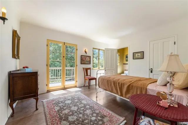 a living room with a bed furniture and a window