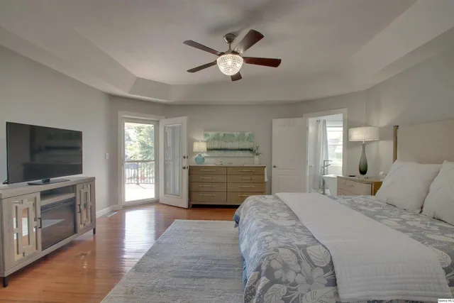 a bedroom with a bed and a chandelier