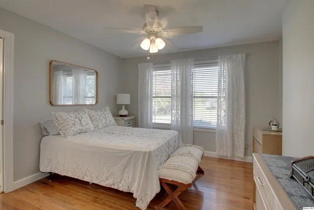 a spacious bedroom with a bed and a chandelier