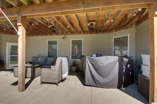 a view of a house with backyard porch and furniture