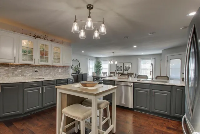 a kitchen with a center island appliances and cabinets