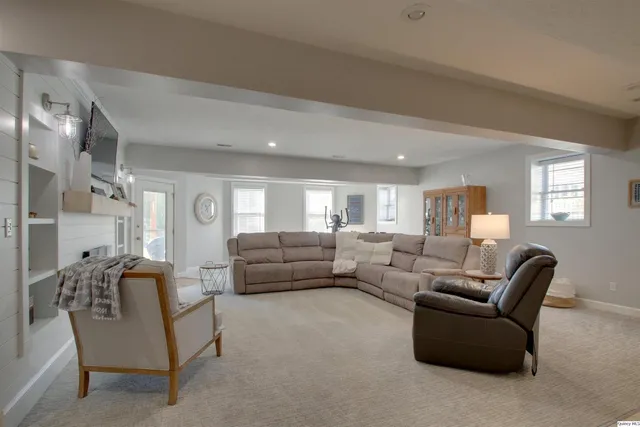 a view of a hallway with windows and chandelier