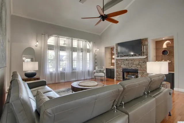 a living room with furniture a flat screen tv and a fireplace