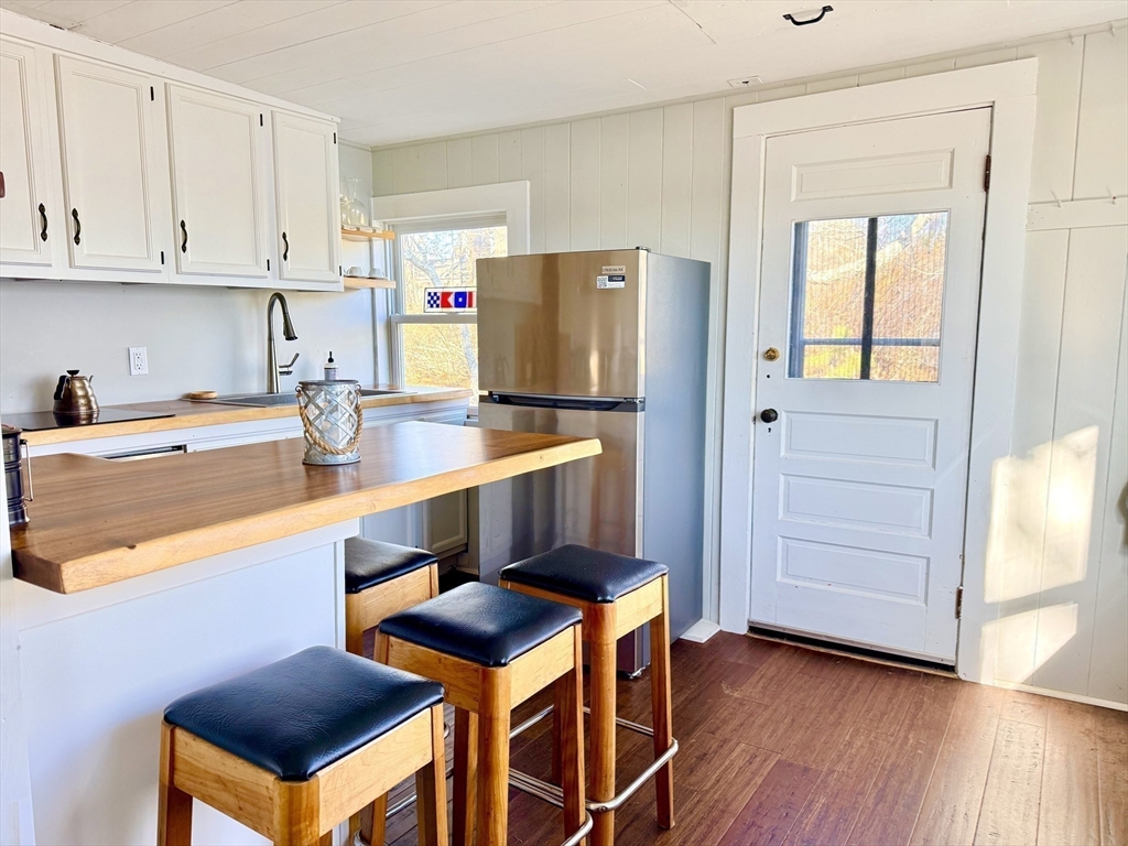 43 Pond Street, Unit 11 Dennis, MA 02670 - Photo 14 of 37 a kitchen with stainless steel appliances a stove a refrigerator and cabinets