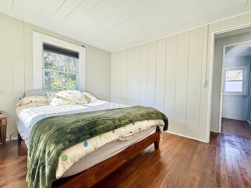 43 Pond Street, Unit 11 Dennis, MA 02670 - Photo 21 of 37 a bed sitting in a bedroom next to a window