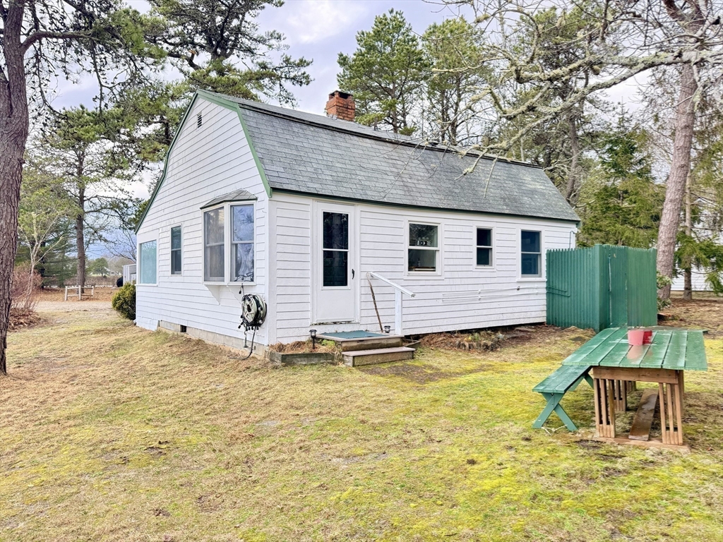 43 Pond Street, Unit 11 Dennis, MA 02670 - Photo 32 of 37 a view of a house with pool and chairs