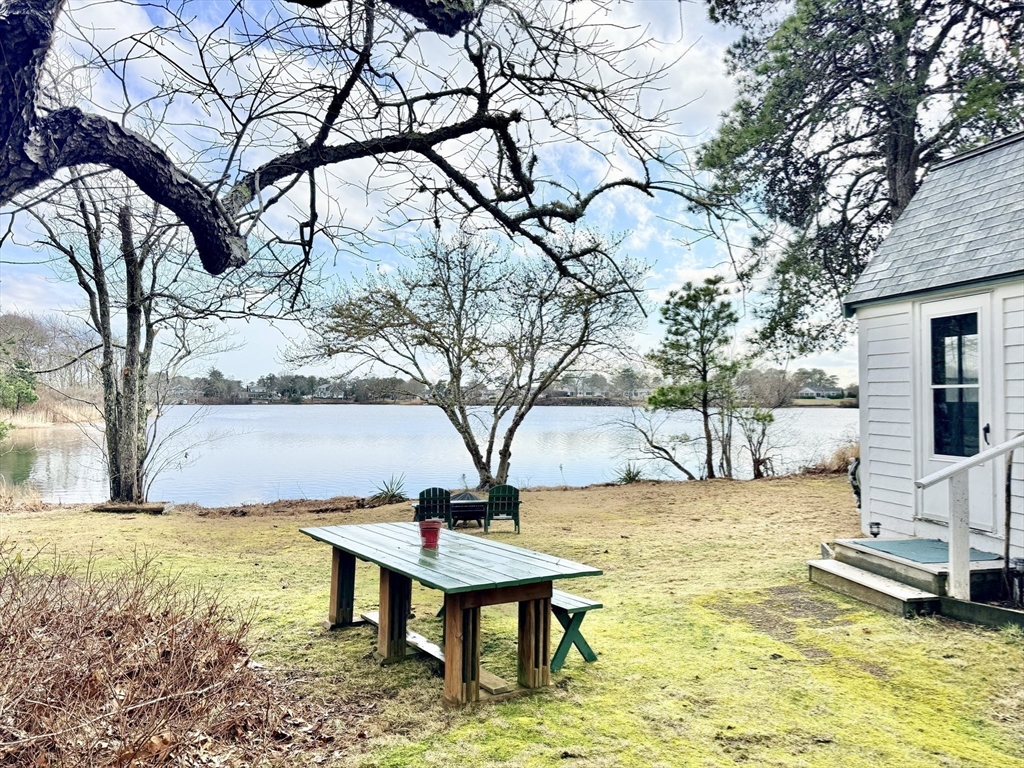 43 Pond Street, Unit 11 Dennis, MA 02670 - Photo 36 of 37 a view of a swimming pool with a bench