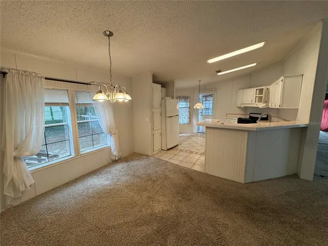 a view of a kitchen with a sink and cabinet